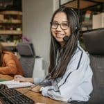 Customer support representative working in a modern office environment, providing assistance.